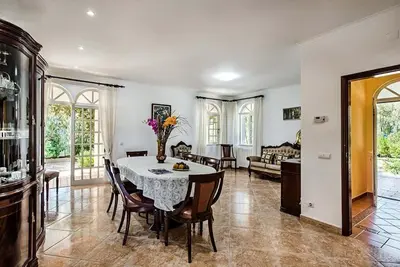 a kitchen and dining room with a table and chairs at Villa Cabrita, Superb location, large villa, walk to restaurants, supermarkets beach in Guia