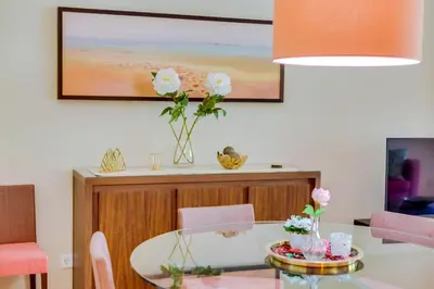 a dining room with a table with flowers on it at AL - Apartamento Vila Sol F5 AB in Vilamoura