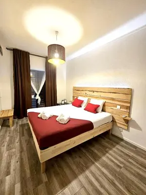 a bedroom with a large bed with red pillows at Albufeira Old Town T3 with Balcony in Albufeira