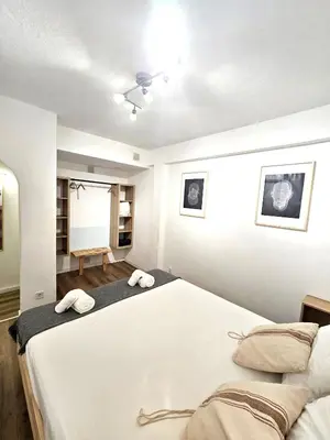 a bedroom with a large bed with two towels at Albufeira Old Town T3 with Balcony in Albufeira