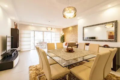 a dining room and living room with a table and chairs at ALBUFEIRA (OLD TOWN) VERASOL AA - THE LUXURY STAY in Albufeira
