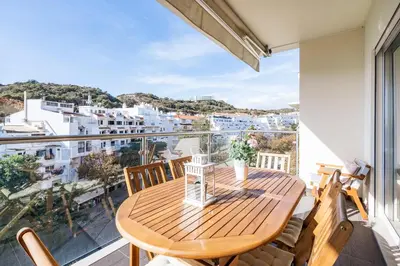 a wooden table on a balcony with a view of the city at ALBUFEIRA (OLD TOWN) VERASOL AA - THE LUXURY STAY in Albufeira