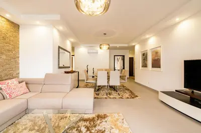 a living room with a couch and a tv at ALBUFEIRA (OLD TOWN) VERASOL AA - THE LUXURY STAY in Albufeira