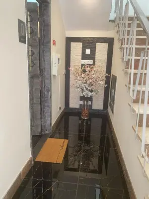 a hallway with a vase of flowers on the floor at AL Barbinha in Faro