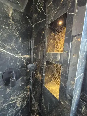a bathroom with a shower with a glass door at AL Barbinha in Faro