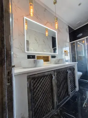 a bathroom with a vanity with two sinks and a mirror at AL Barbinha in Faro