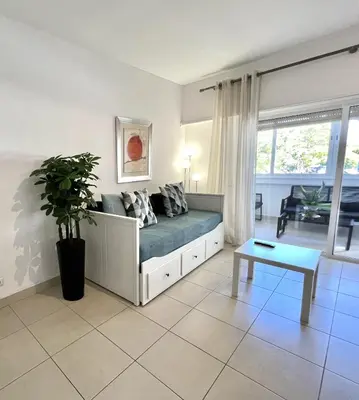 a living room with a couch and a table at Torre 20 - Near the beach - Quarteira in Quarteira