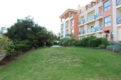 a large grassy yard in front of a building at Charming 3-Bed Apartment in Albufeira in Albufeira