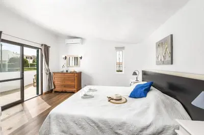 a bedroom with a bed with a hat on it at Villa Lilly by Villa Plus in Albufeira