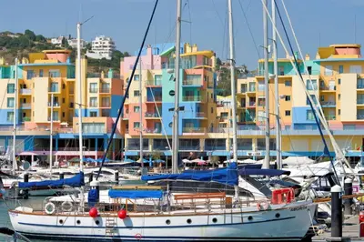 a group of boats docked in a marina with buildings at Villa Lilly by Villa Plus in Albufeira