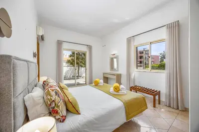 a bedroom with a large bed and a window at Villa Miraflores by Villa Plus in Albufeira