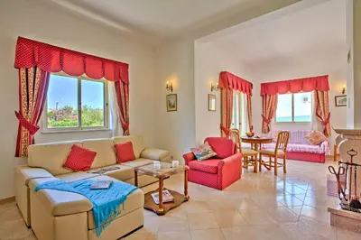 a living room with a couch and chairs and a table at Villa Miraflores by Villa Plus in Albufeira