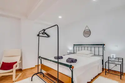 a bedroom with a bed and a large mirror at Villa Rafaela com piscina Albufeira in Albufeira