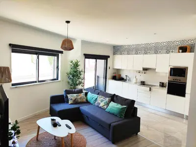a living room with a couch and a table at Apartamento Rooftop Montenegro in Faro