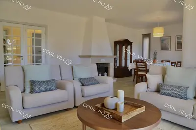 a living room with two couches and a coffee table at Villa Lilac - walking distance to beach in Albufeira