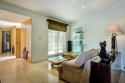 a living room with a couch and a table at Villa Laguna, Golf - Stunning house - Laguna Golf Course in Quarteira