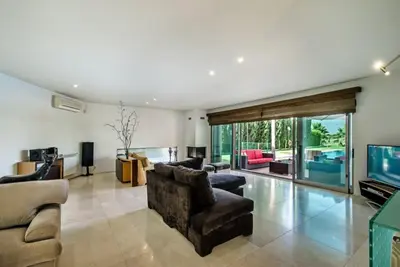 a living room with a couch and a television at Villa Laguna, Golf - Stunning house - Laguna Golf Course in Quarteira