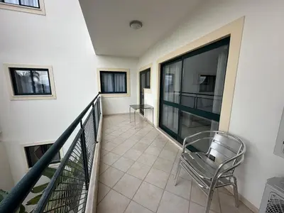 a balcony with a chair and a window at BayView Albufeira in Albufeira