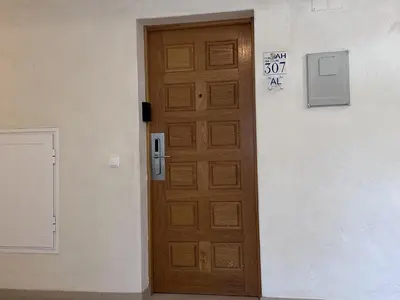 a wooden door in a building with a sign on it at BayView Albufeira in Albufeira