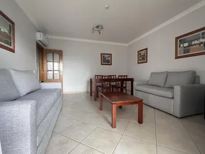 a living room with two couches and a table at BayView Albufeira in Albufeira