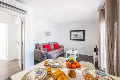 a living room with a table and a couch at Atlantic Breeze Apartments by Atlantic Places in Albufeira