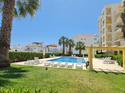 a living room with a table and a dining room at Mar a Vista in Albufeira