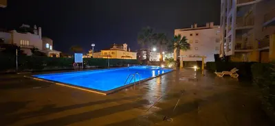 a swimming pool with blue water and metal rails at Mar a Vista in Albufeira