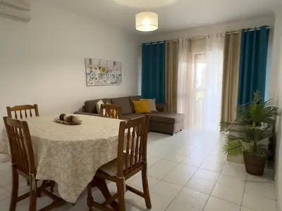 a living room with a table and a couch at Apartamento Margarita in Quarteira