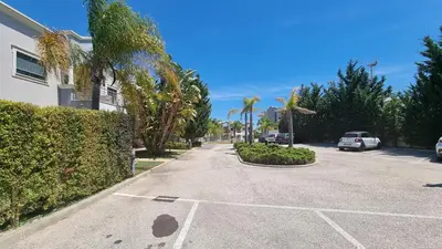 a street with cars parked in a parking lot at Quinta do Pinheiro Premium by Sunny Deluxe in Olhos de Água