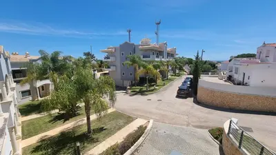arial view of a street with palm trees and buildings at Quinta do Pinheiro Premium by Sunny Deluxe in Olhos de Água