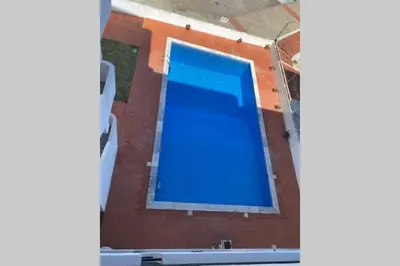 a large blue swimming pool in a building at Casa d'Avó by RPG Properties in Albufeira