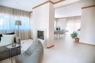 a living room with a couch and a fireplace at Plant Paradise Apartment in Albufeira