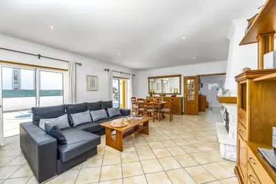 a living room with a couch and a table at Villa Anamar by Villa Plus in Albufeira