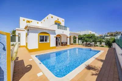 a villa with a swimming pool in front of a house at Villa Anamar by Villa Plus in Albufeira