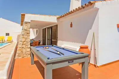 a pool table sitting on a patio next to a house at Villa Aveiros by Villa Plus in Albufeira