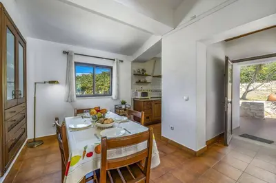 a kitchen and dining room with a table and chairs at Villa Aveiros by Villa Plus in Albufeira