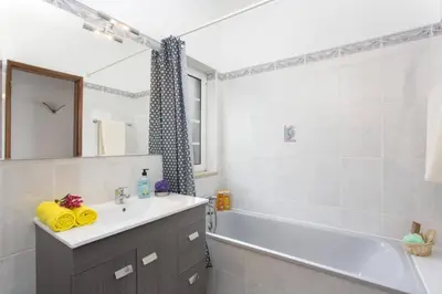 a bedroom with two beds and a desk and a mirror at Villa Gale Palm by Villa Plus in Albufeira