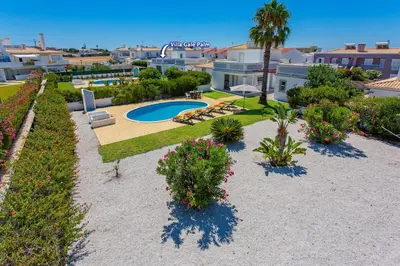 a resort yard with a swimming pool and plants at Villa Hope by Villa Plus in Galé
