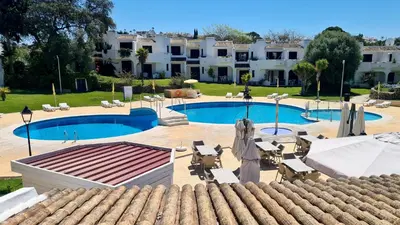 a resort with a swimming pool and a building at Green and Blue View Apartment in Albufeira