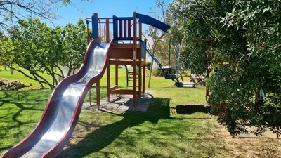 a slide on a playground in a park at Green and Blue View Apartment in Albufeira