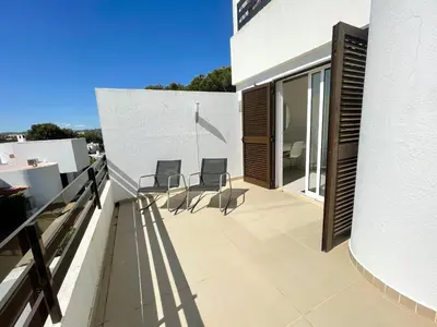 a balcony of a house with chairs on it at Casa Rosa - Vilamoura in Vilamoura