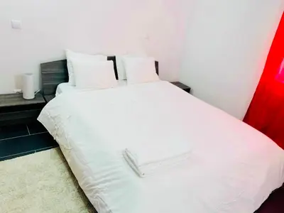 a white bed with white towels on top of it at Albufeira Beach side Apartment in Albufeira