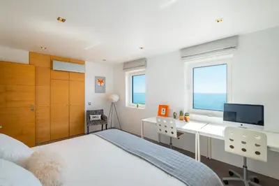 a bedroom with a bed with a flower patterned comforter at #041 Future House by Home Holidays in Albufeira