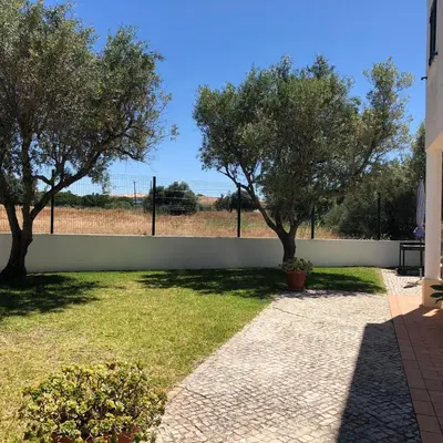 a garden with two trees and a fence at Villa Nox in Brejos