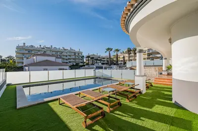 a swimming pool in front of a house at Villa Thetis by Atlantic Places in Albufeira