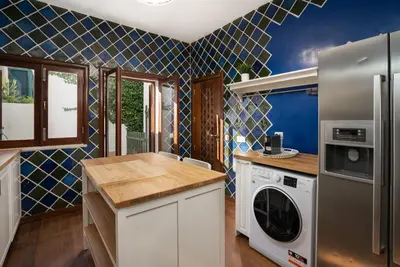 a kitchen with a refrigerator and a dishwasher at Holiday villa in elite residential area of Faro in Faro