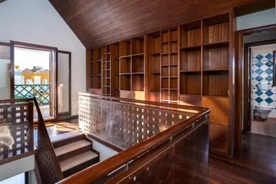 a staircase in a room with wooden walls and shelves at Holiday villa in elite residential area of Faro in Faro