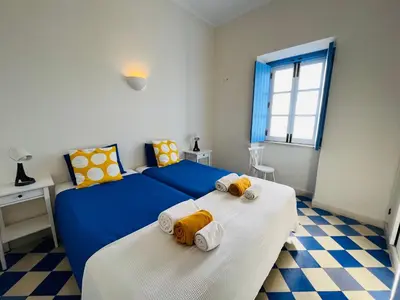 a bedroom with two beds with towels on them at Casa da Praia in Albufeira