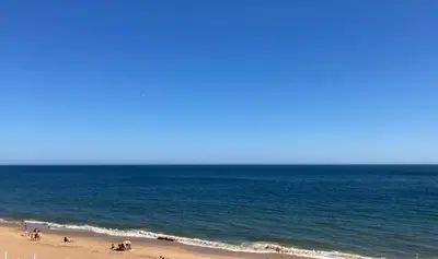 a group of people on a beach near the ocean at Casa da Praia in Albufeira