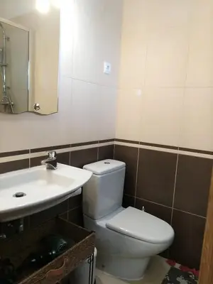 a bathroom with a white toilet and a sink at Garden View Vilamoura Apartment in Vilamoura